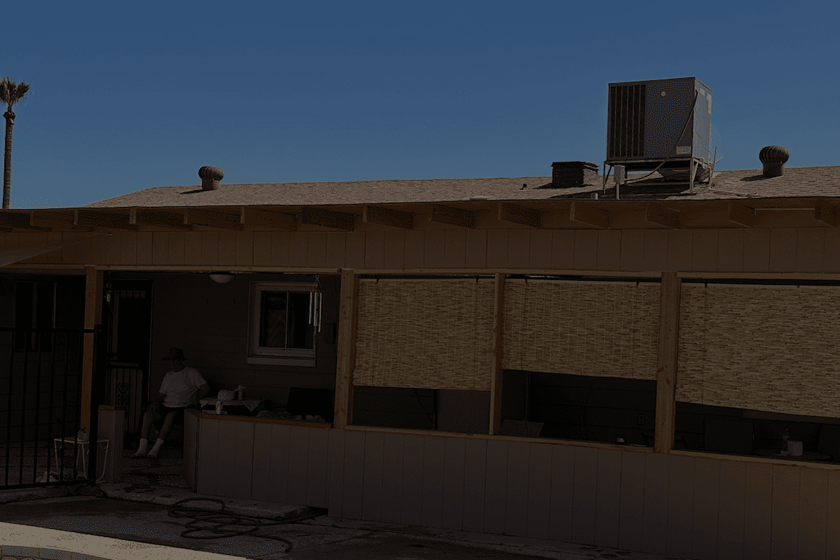 Single-story building with beige walls and a flat roof under a clear sky.